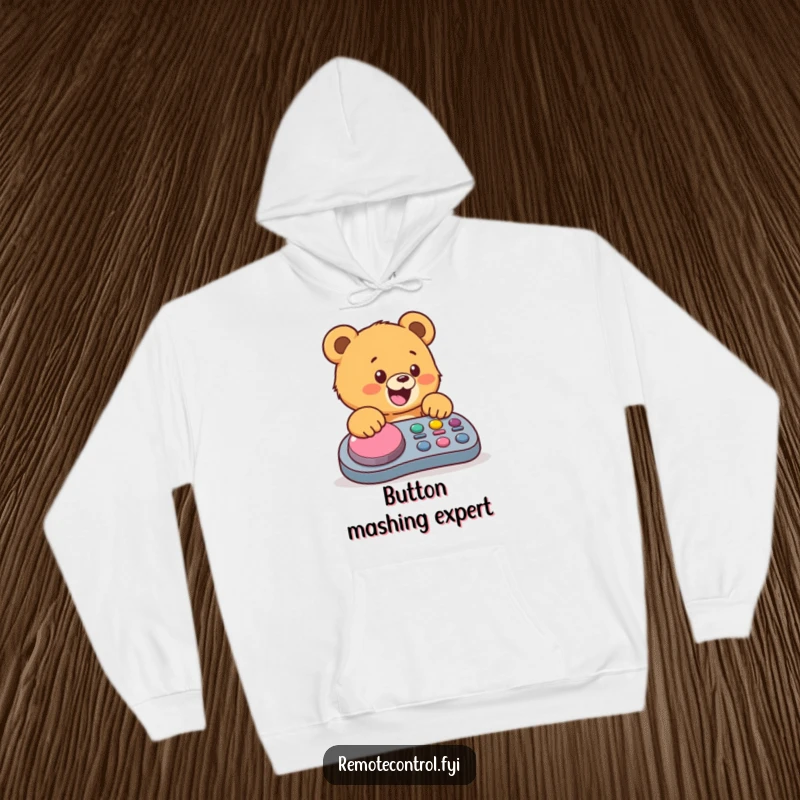 Funny bear cub hoodie, showing a cheerful cub mashing a big button on a remote, perfect for cozy, humorous wear.