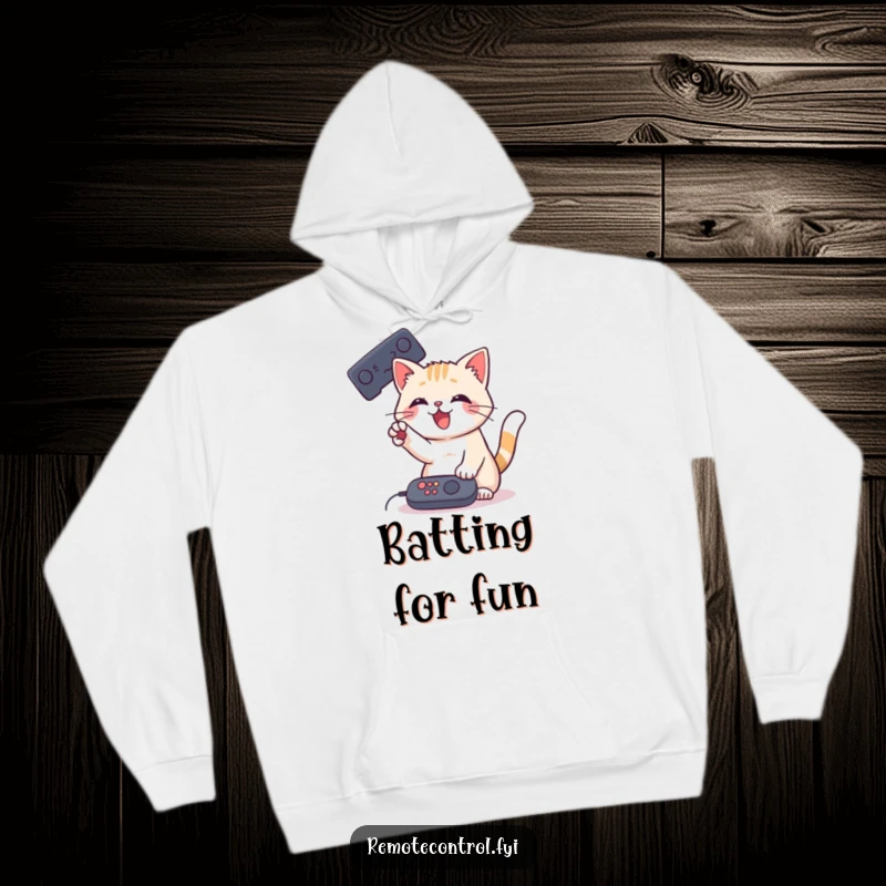 Funny Cat Remote Hoodie showcasing a playful cat batting at a remote control with its paw, designed for warmth and humor.