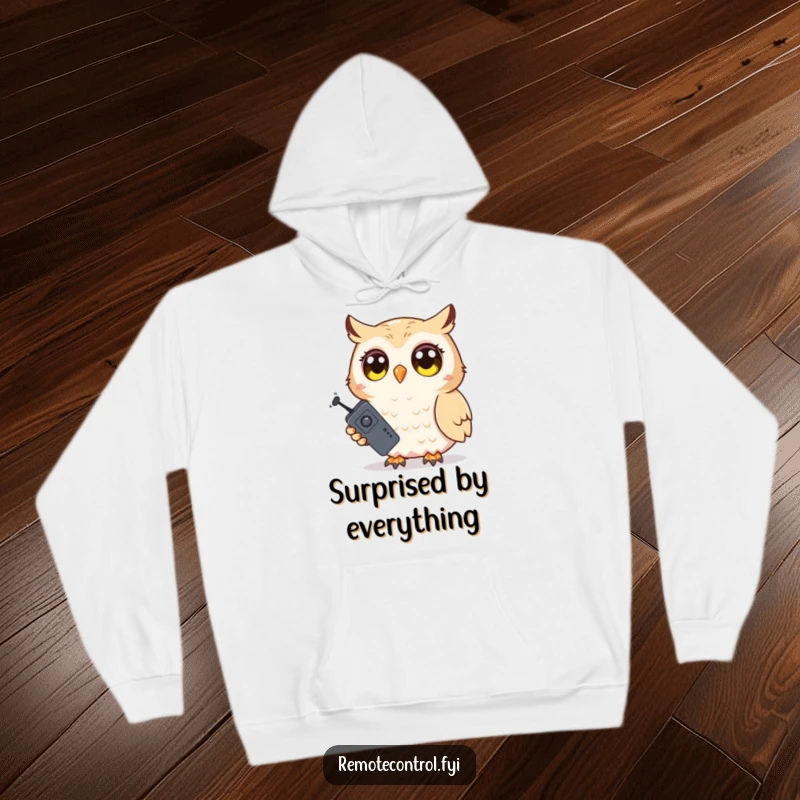 Funny Owl Hoodie: Shy owl character holding a TV remote with wide, surprised eyes, ideal for relaxing and watching shows.