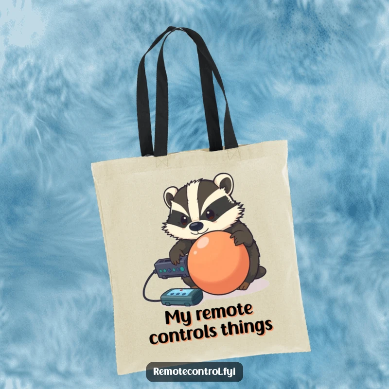Funny determined badger using a remote to control a rolling ball, displayed on a functional and humorous tote bag.